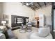 Open-concept living room with kitchen bar, modern decor, and a built-in media center at 572 Edgewood Ne Ave # 301, Atlanta, GA 30312