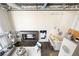 Open-concept living room with concrete floors, custom built-ins, and modern kitchen at 572 Edgewood Ne Ave # 301, Atlanta, GA 30312