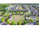 Aerial view of a suburban home near a central neighborhood green space and gazebo at 6425 Bellmoore Park Ln, Johns Creek, GA 30097