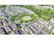 A high-angle shot of a lovely community park with a gazebo, water feature, sidewalks, and surrounding homes at 6425 Bellmoore Park Ln, Johns Creek, GA 30097