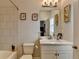 Bathroom featuring a shower-tub combo and framed wall art above the toilet at 6425 Bellmoore Park Ln, Johns Creek, GA 30097
