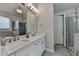 Beautiful bathroom featuring double vanity, large mirror, and separate shower and tub at 6425 Bellmoore Park Ln, Johns Creek, GA 30097