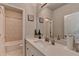 Bright bathroom featuring white countertops, tiled shower, and modern fixtures at 6425 Bellmoore Park Ln, Johns Creek, GA 30097