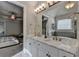 Bathroom with dual vanities, marble countertops, and great lighting at 6425 Bellmoore Park Ln, Johns Creek, GA 30097