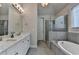 Gorgeous bathroom with double vanity, soaking tub and tiled walk-in shower at 6425 Bellmoore Park Ln, Johns Creek, GA 30097