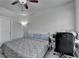Bedroom with a queen-size bed, a desk with windows, and a cozy interior at 6425 Bellmoore Park Ln, Johns Creek, GA 30097