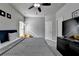 Well-lit bedroom featuring a ceiling fan, plush carpet, and modern furniture at 6425 Bellmoore Park Ln, Johns Creek, GA 30097