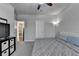 Spacious bedroom featuring plush carpeting, ceiling fan, and a comfortable queen-size bed at 6425 Bellmoore Park Ln, Johns Creek, GA 30097