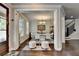 Elegant dining room with a modern chandelier, white table setting, and decorative accents at 6425 Bellmoore Park Ln, Johns Creek, GA 30097
