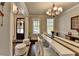 Cozy dining area with a large table, hardwood floors, and ample natural light from the adjacent doorway at 6425 Bellmoore Park Ln, Johns Creek, GA 30097
