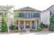 Charming two-story home with a welcoming front porch, beautiful landscaping, and meticulous yard at 6425 Bellmoore Park Ln, Johns Creek, GA 30097