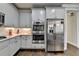 Modern kitchen featuring stainless steel appliances, sleek white cabinetry, and marble countertops at 6425 Bellmoore Park Ln, Johns Creek, GA 30097