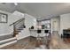 Modern kitchen area with bar seating, stainless steel appliances, and hardwood flooring at 6425 Bellmoore Park Ln, Johns Creek, GA 30097