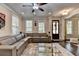 Open-concept living room with hardwood floors, a comfortable sectional couch, and lots of natural light at 6425 Bellmoore Park Ln, Johns Creek, GA 30097