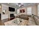 Bright living room features a fireplace, stylish decor, and plenty of space for entertaining at 6425 Bellmoore Park Ln, Johns Creek, GA 30097