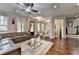 Spacious living room flows to dining area, features hardwood floors, and stylish furniture at 6425 Bellmoore Park Ln, Johns Creek, GA 30097