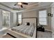 This main bedroom offers plush carpet, ample lighting, and access to the main bathroom at 6425 Bellmoore Park Ln, Johns Creek, GA 30097