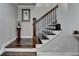 Elegant staircase with dark wood treads, white risers and black iron balusters at 6425 Bellmoore Park Ln, Johns Creek, GA 30097