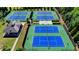 Aerial view of community tennis courts showing fencing, sidewalks, and clubhouse at 6425 Bellmoore Park Ln, Johns Creek, GA 30097