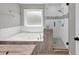 Bathroom features a tub, glass enclosed shower, and updated finishes at 1960 Barnes Mill Rd, Marietta, GA 30062