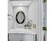 Powder room featuring a marble countertop and ornate oval mirror at 1960 Barnes Mill Rd, Marietta, GA 30062