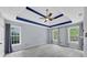 Spacious bedroom features a tray ceiling with fan, and windows letting in natural light at 1960 Barnes Mill Rd, Marietta, GA 30062