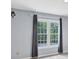 Bedroom featuring a large window, neutral paint, carpet, and curtains at 1960 Barnes Mill Rd, Marietta, GA 30062