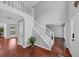 Inviting foyer with hardwood floors, a staircase, and natural light filtering through the front door at 1960 Barnes Mill Rd, Marietta, GA 30062