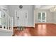 Bright foyer featuring hardwood floors, a staircase with white railings, and elegant lighting fixtures at 1960 Barnes Mill Rd, Marietta, GA 30062