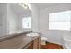 This bathroom features an extended vanity, tile floors, and a shower-tub combo at 2565 Feywood Ct, Lithonia, GA 30058