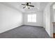 Main bedroom with tray ceiling, carpet flooring, and natural light at 2565 Feywood Ct, Lithonia, GA 30058