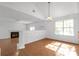 Open dining room featuring a modern chandelier, fireplace, and tile flooring at 2565 Feywood Ct, Lithonia, GA 30058