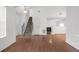 Open-concept living area with hardwood floors, staircase, and fireplace at 2565 Feywood Ct, Lithonia, GA 30058