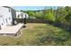 Large backyard featuring a patio with outdoor dining and a spacious grassy area at 269 Shoals Bridge Rd, Acworth, GA 30102