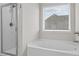 Bathroom featuring a soaking tub, shower, and natural light at 269 Shoals Bridge Rd, Acworth, GA 30102