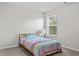 Well-lit bedroom with a colorful bedspread and carpet flooring at 269 Shoals Bridge Rd, Acworth, GA 30102