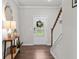 Welcoming foyer with hardwood floors, staircase, and natural light filtering through the front door at 269 Shoals Bridge Rd, Acworth, GA 30102