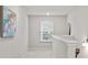 Bright hallway featuring neutral paint, modern light fixture, and decorative wall art at 269 Shoals Bridge Rd, Acworth, GA 30102