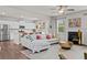 Open-concept living area with modern furniture, stainless steel appliances, and a cozy fireplace at 269 Shoals Bridge Rd, Acworth, GA 30102