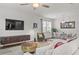 Bright living room featuring modern furnishings, a ceiling fan, and a dining area with hardwood floors at 269 Shoals Bridge Rd, Acworth, GA 30102