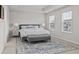 Spacious main bedroom with a comfortable bed, bench, patterned rug, and plenty of natural light at 269 Shoals Bridge Rd, Acworth, GA 30102