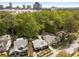 Aerial view of the neighborhood with mature trees and city skyline in the distance at 4 Arc Ne Way, Atlanta, GA 30305