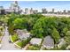 Bird's eye view of homes surrounded by lush greenery, with city buildings visible on the horizon at 4 Arc Ne Way, Atlanta, GA 30305