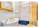 Bathroom featuring a pedestal sink and a blue bathtub with gold fixtures at 4 Arc Ne Way, Atlanta, GA 30305