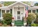 Charming home with inviting front porch, American flag, and lush landscaping at 4 Arc Ne Way, Atlanta, GA 30305