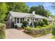 Charming home with brick driveway, walkway, well-kept landscaping and inviting covered front porch at 4 Arc Ne Way, Atlanta, GA 30305