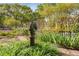 Landscaped front garden featuring a horse statue among flowers and greenery at 4 Arc Ne Way, Atlanta, GA 30305