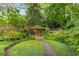 Beautiful backyard gazebo surrounded by flowers and lush greenery, perfect for relaxing outdoors at 4 Arc Ne Way, Atlanta, GA 30305