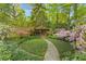 Beautiful backyard gazebo surrounded by flowers and lush greenery, perfect for relaxing outdoors at 4 Arc Ne Way, Atlanta, GA 30305
