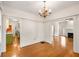 Open layout featuring hardwood floors and neutral paint, connecting the kitchen, dining, and living spaces at 4 Arc Ne Way, Atlanta, GA 30305